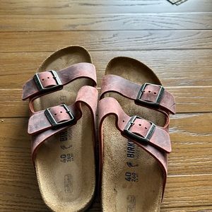 Waxed leather never worn Birkenstock double strap sandals in a muted red color.